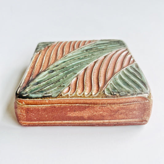 square wall tile with hand carved leaf pattern