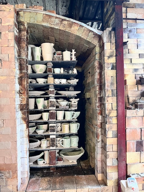 Joy Tanner's gas fired soda kiln with bisqued and glazed pots loaded inside before the firing begins.