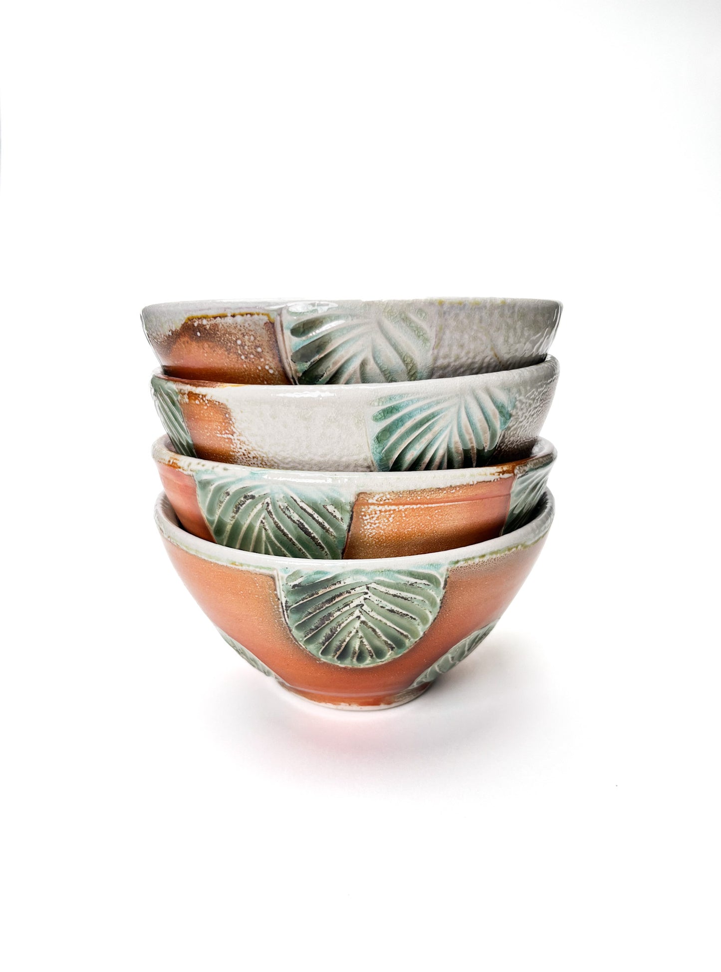 This bowl is a great size for cereal, soup or salad. The hand carved green leaf pattern is inspired by nature. The rest of the piece is varied earth tones, with a interior white glaze.