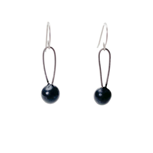Black handmade earrings that resemble seeds. Hypoallergenic ear wires
