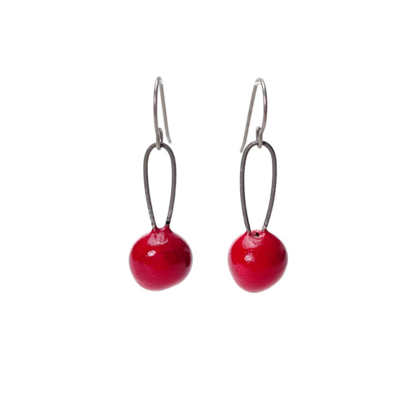 Red handmade earrings that resemble seeds. Hypoallergenic ear wires