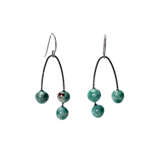 Green handmade earrings that resemble seeds. Hypoallergenic ear wires