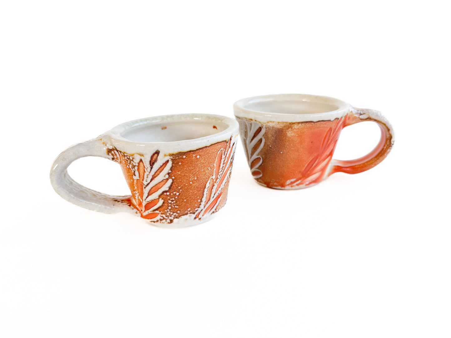 Brighten up your morning espresso with these unique cups! They have a handcarved leaf pattern around the sides.