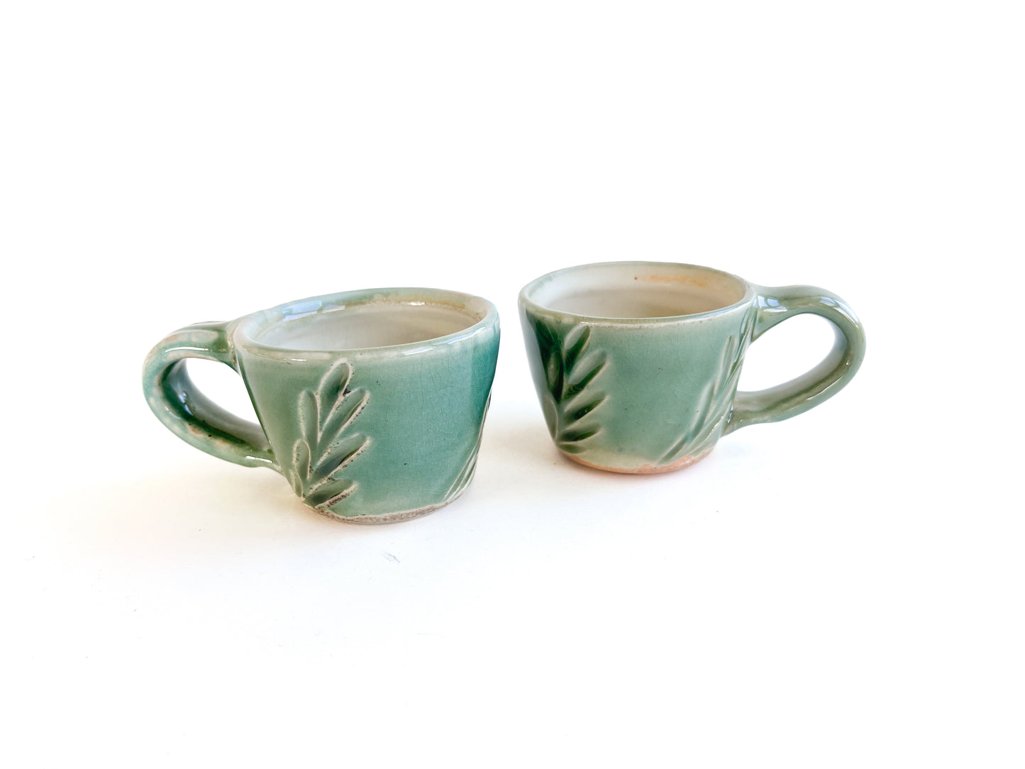 Brighten up your morning espresso with these unique green cups! They have a handcarved leaf pattern around the sides.