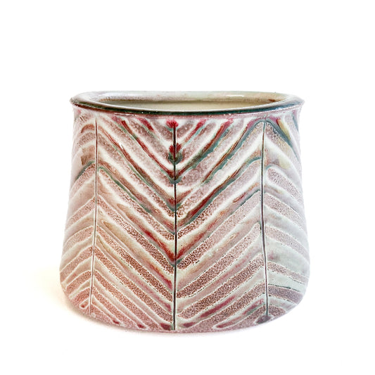 This beautiful oval flower vase has a carved leaf design with greem, purple, red and white mixed tones.