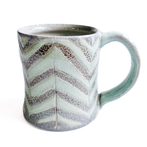 pale green handmade pottery mug with striped pattern
