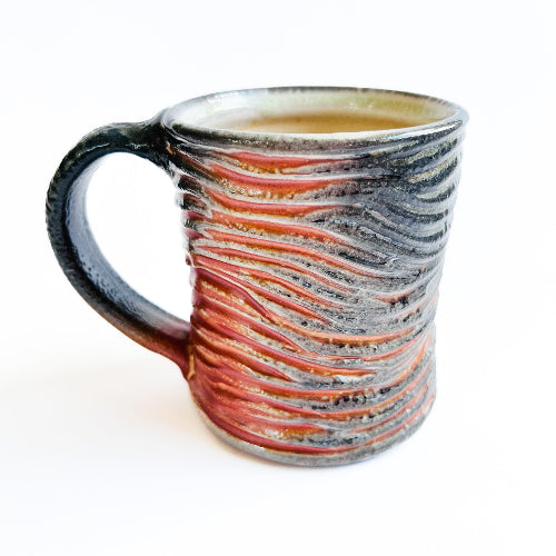 earth toned handmade pottery mug with handcarved texture