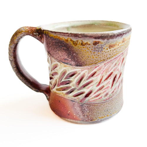 earth toned handmade pottery mug with handcarved texture