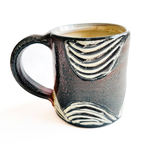earth toned handmade pottery mug with handcarved texture