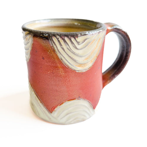 earth toned handmade pottery mug with handcarved texture