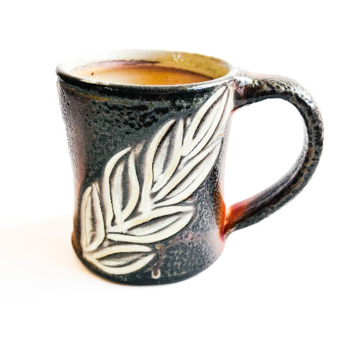 earth toned handmade pottery mug with handcarved texture