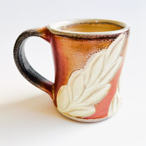 earth toned handmade pottery mug with handcarved texture