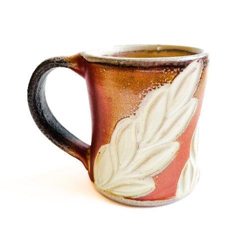 earth toned handmade pottery mug with handcarved texture