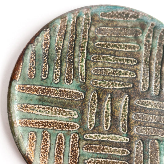 detail of a green patterned small plate