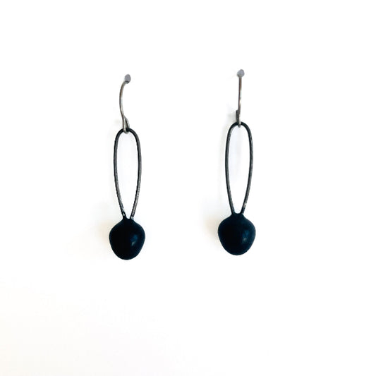 Black earrings with spherical ends on a white background