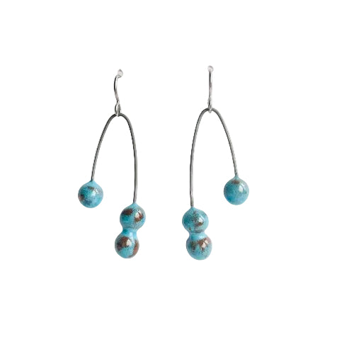 Pair of earrings with turquoise beads on a white background
