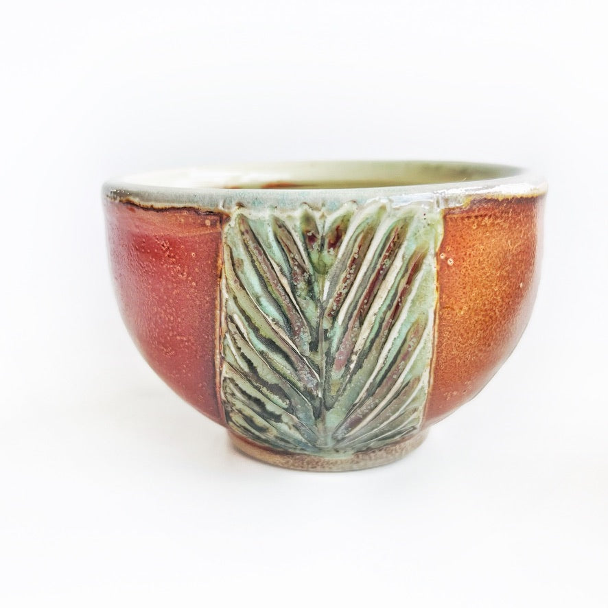 handmade pottery bowls with green carved pattern