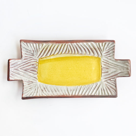 This slab built rectangle dish is great for serving snacks, appetizers, sushi plate, or fun lunch plate! Made from lowfire red earthenware clay, the hand carved white pattern and yellow glaze makes a beautiful statement contrasting with the red clay.