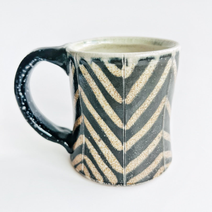 black and white striped pottery mug