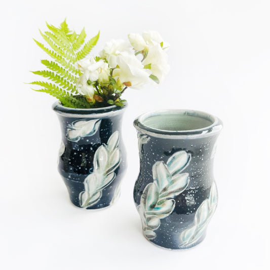 Two black ceramic vases with leaf patterns 
