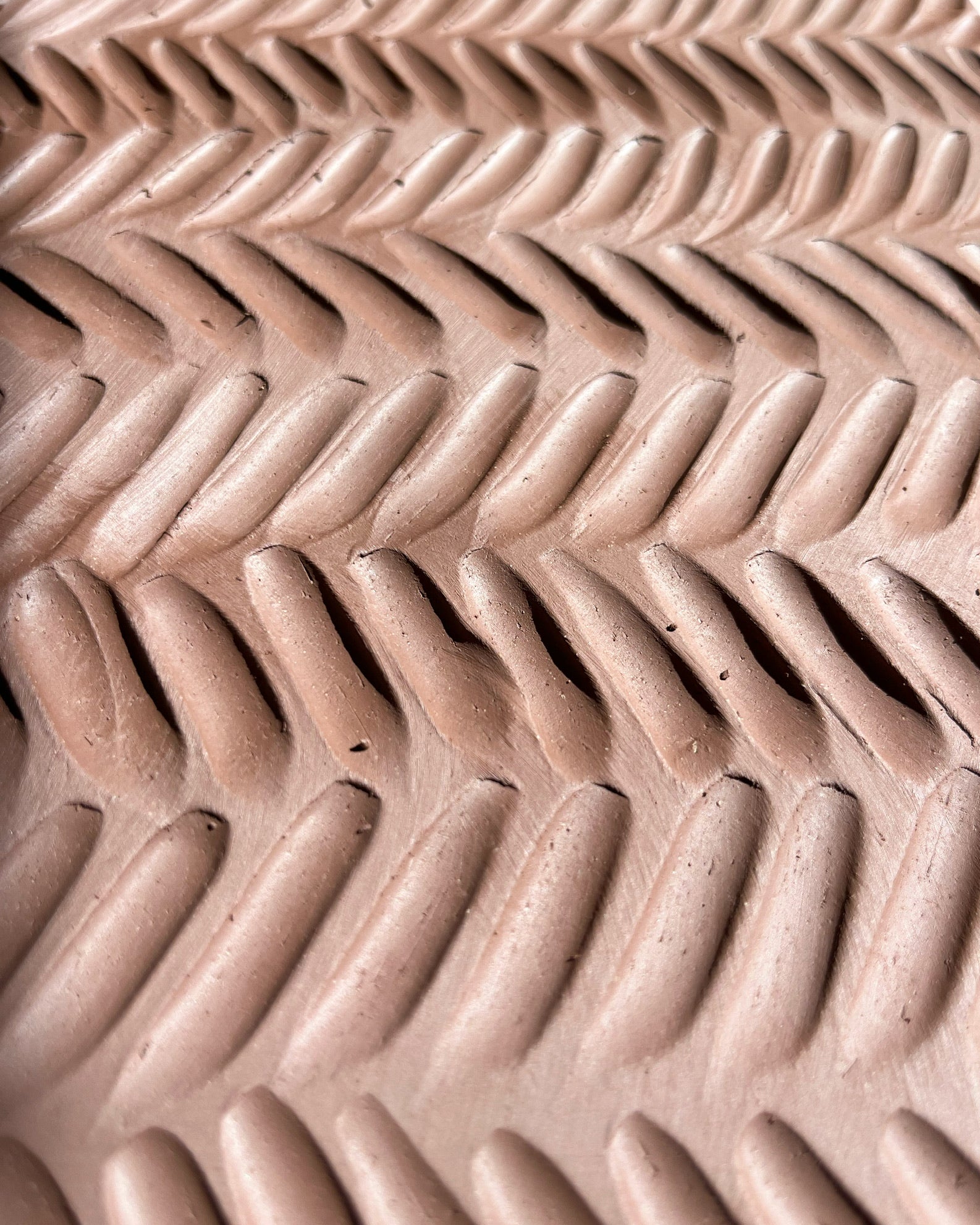 A closeup of Joy's carved lines in an in progress pot