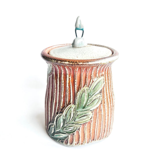 Ceramic incense burner with leaf design on a white background
