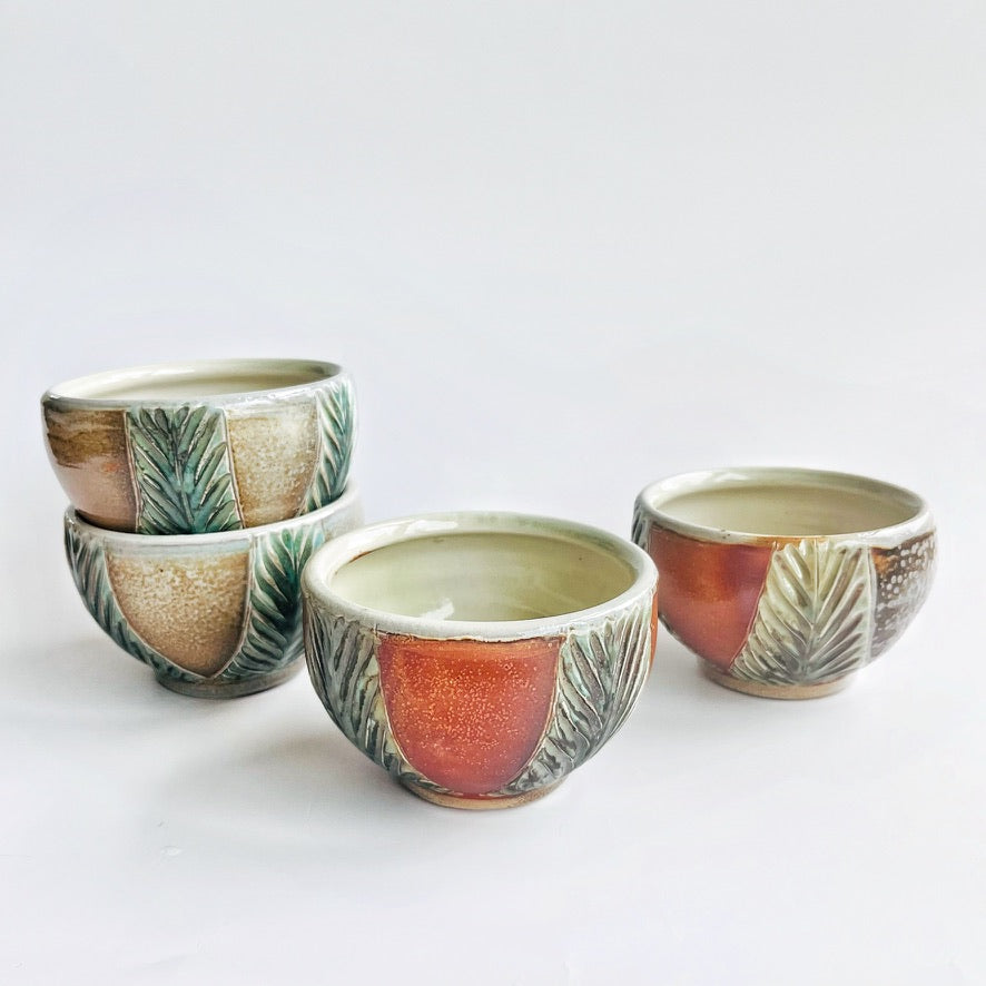handmade pottery bowls with green carved pattern