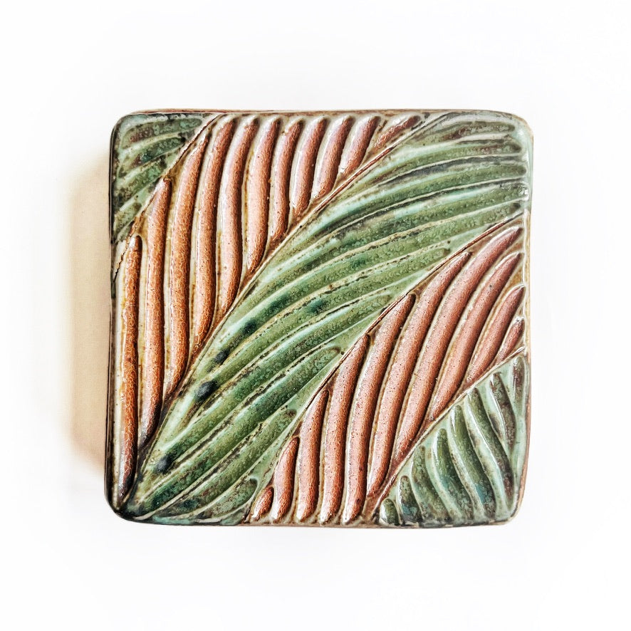 square wall tile with hand carved leaf pattern