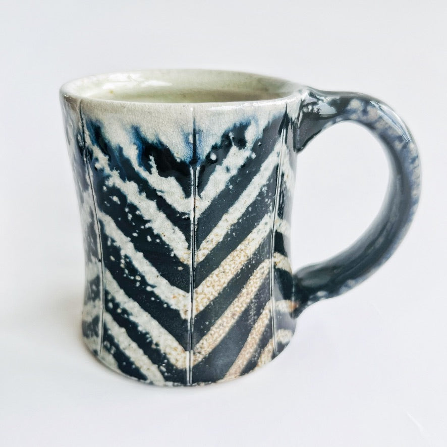 black and white striped pottery mug