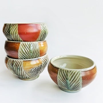 handmade carved earth toned bowls with green patterns