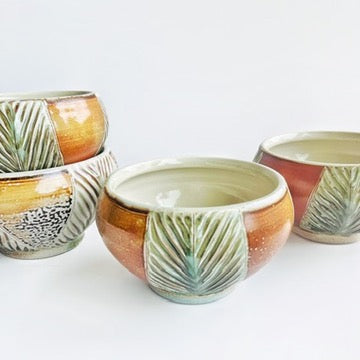 handmade carved earth toned bowls with green patterns