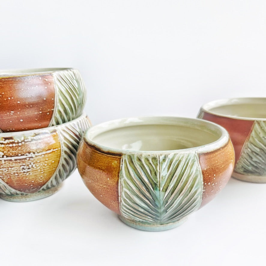 handmade carved earth toned bowls with green patterns