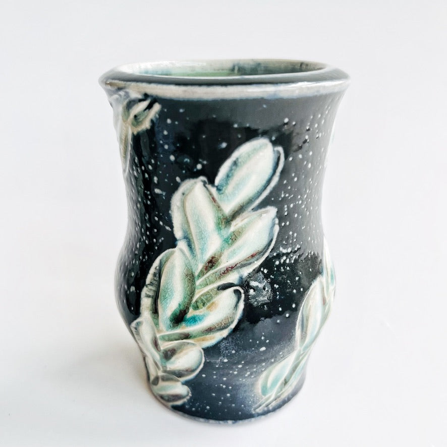 Two black ceramic vases with leaf patterns 