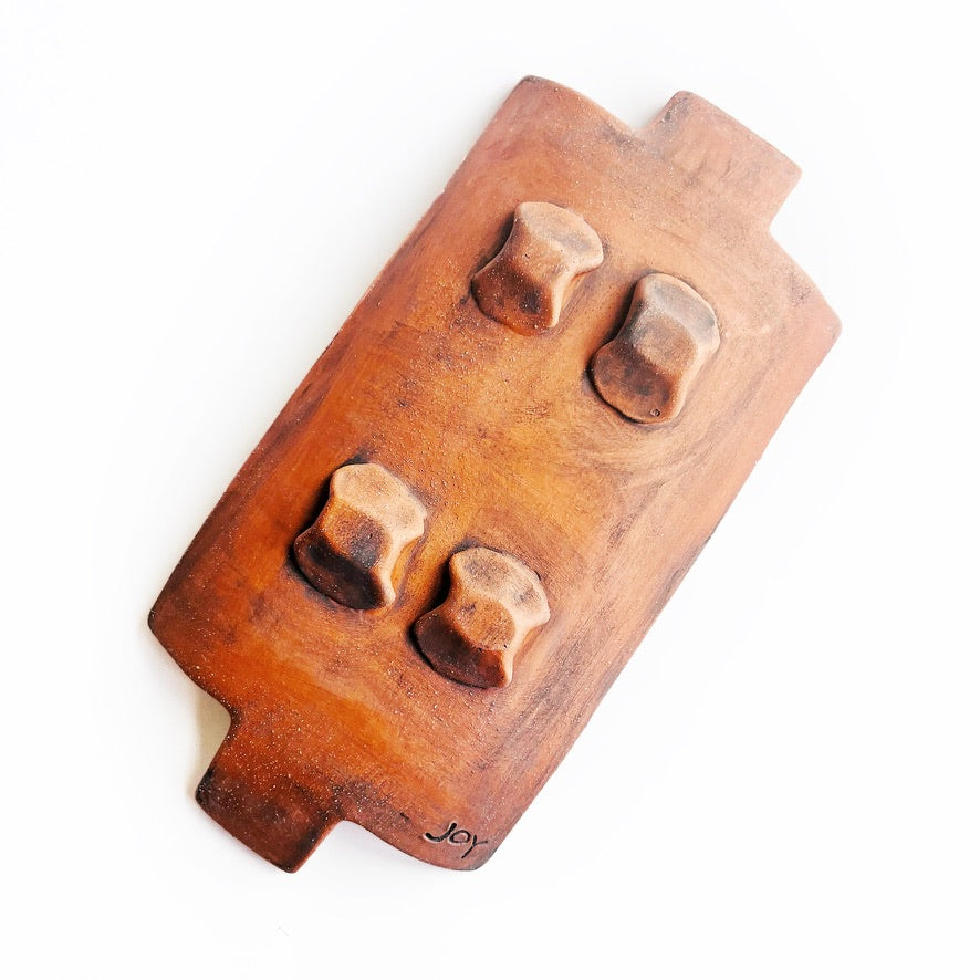 This slab built rectangle dish is great for serving snacks, appetizers, sushi plate, or fun lunch plate! Made from lowfire red earthenware clay, the hand carved white pattern and yellow glaze makes a beautiful statement contrasting with the red clay.