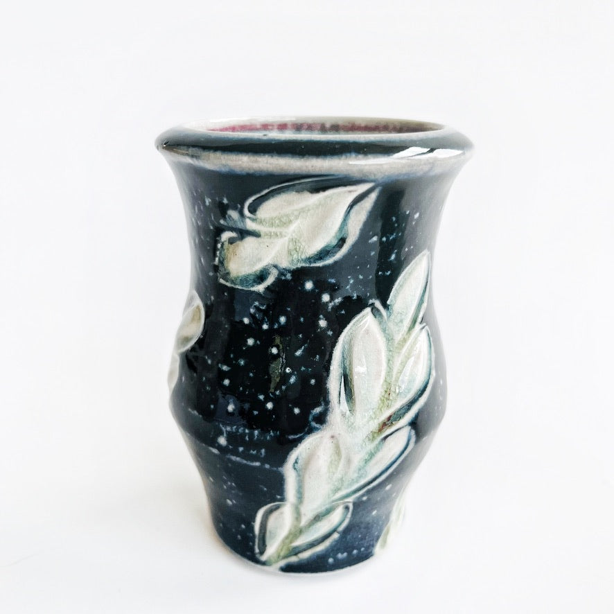 Two black ceramic vases with leaf patterns 