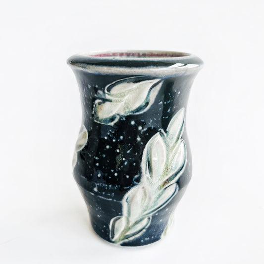 Two black ceramic vases with leaf patterns 