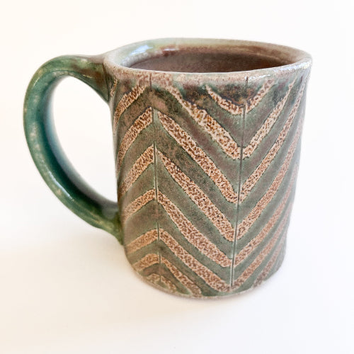 Ceramic mug with chevron pattern on a white background