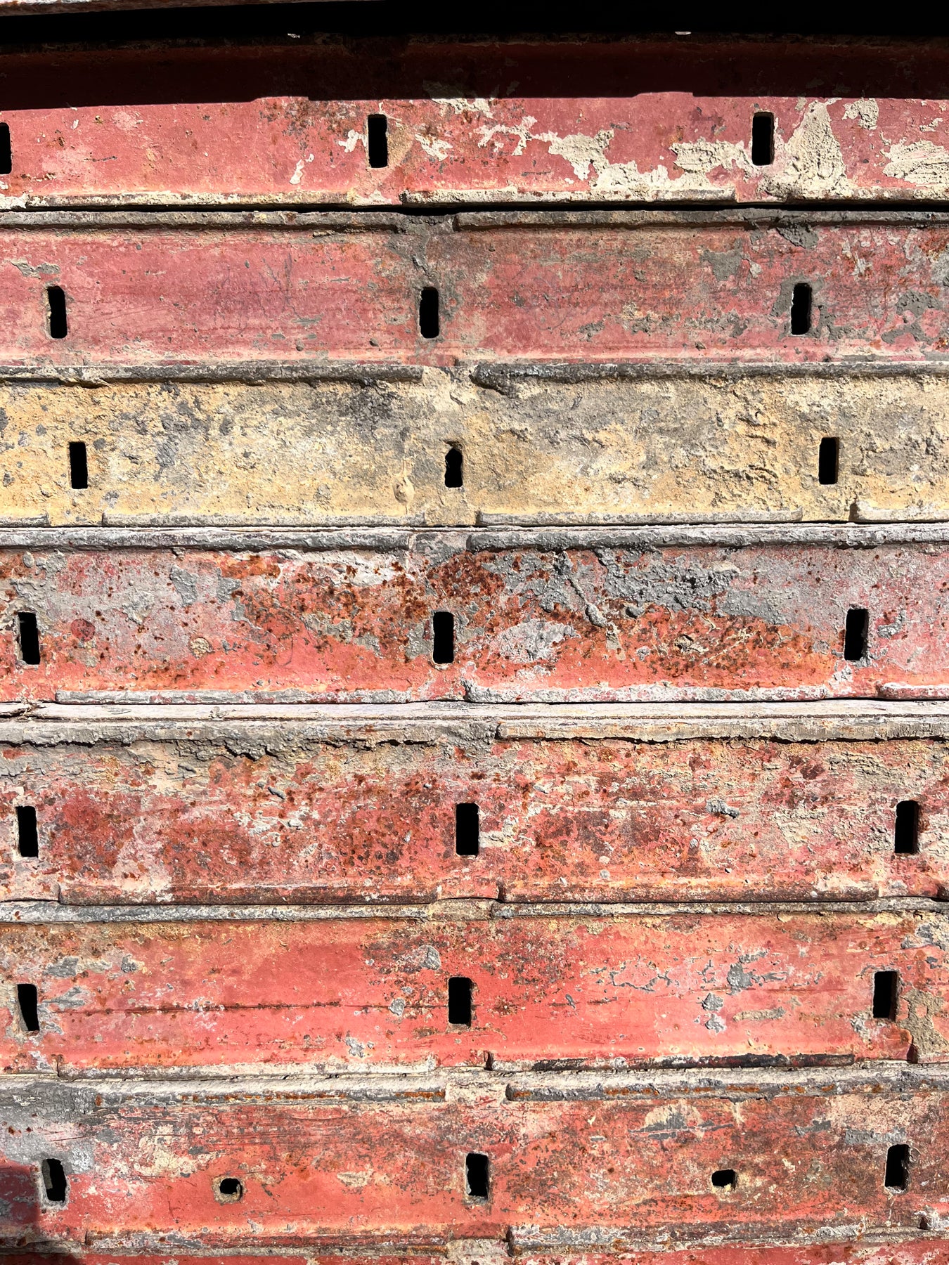 A detail of a weathered red metal surface. 