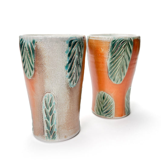 Handmade wheel thrown porcelain tall cups, can also be used as flower vases. Hand carved green leaf pattern around sides of the cup