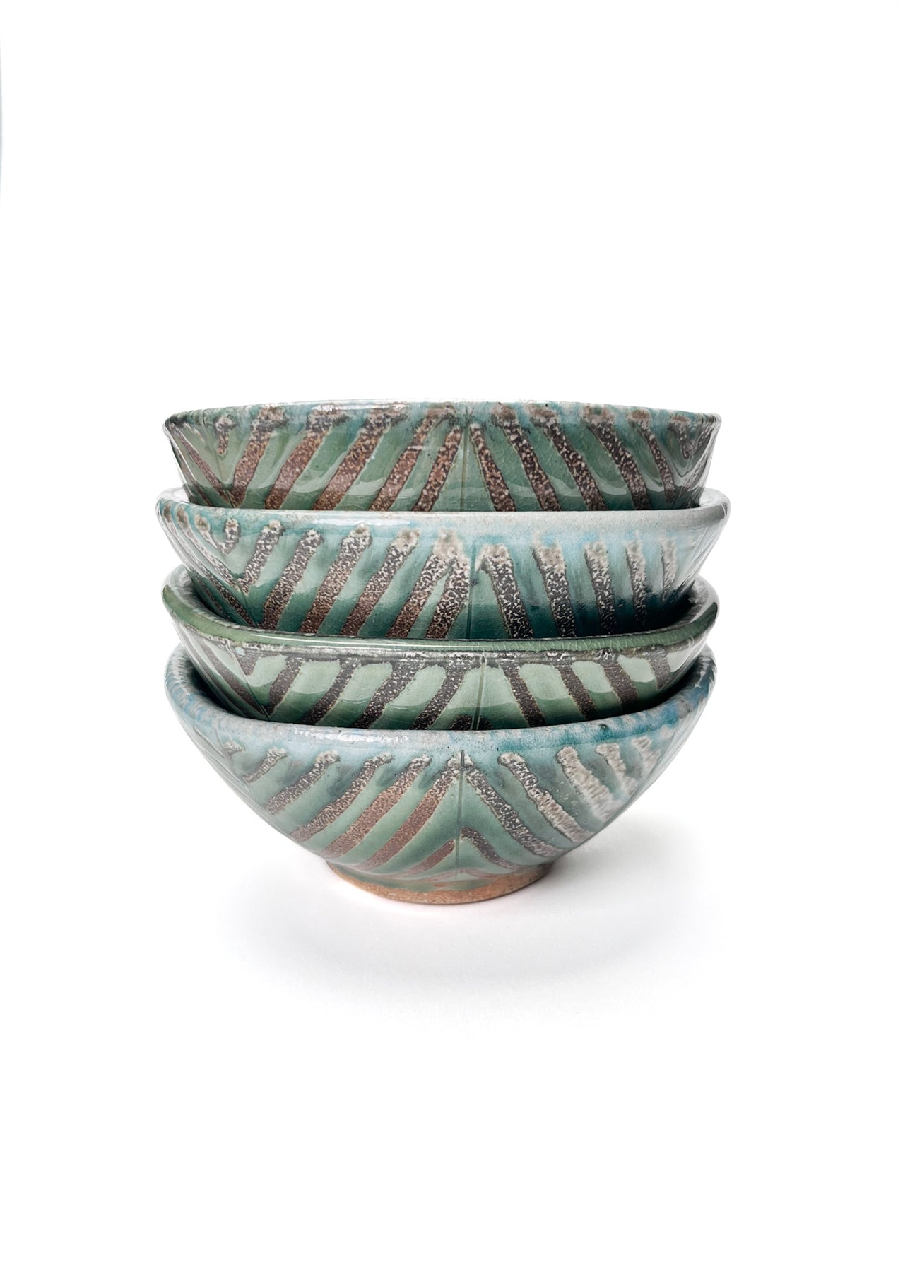 This bowl is a great size for cereal, soup or salad. The hand carved green leaf pattern is inspired by natures and the interior has a white glaze.