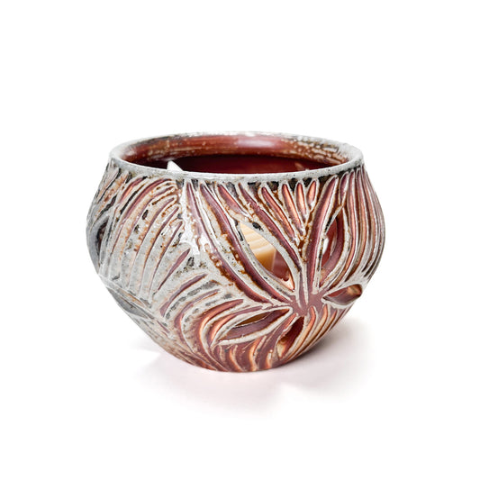 A carved candle holder that shines light out through the pierced holes on the sides when the candle is lit.