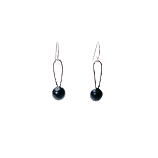 Black handmade earrings that resemble seeds. Hypoallergenic ear wires