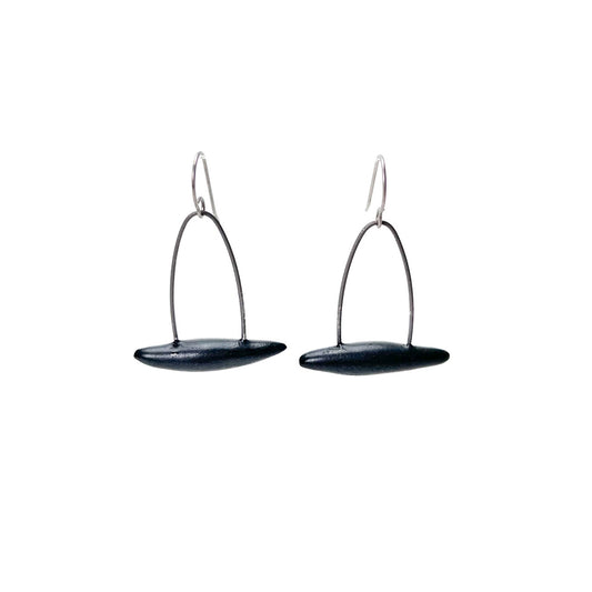 Black handmade earrings that resemble seeds pods. Hypoallergenic ear wires