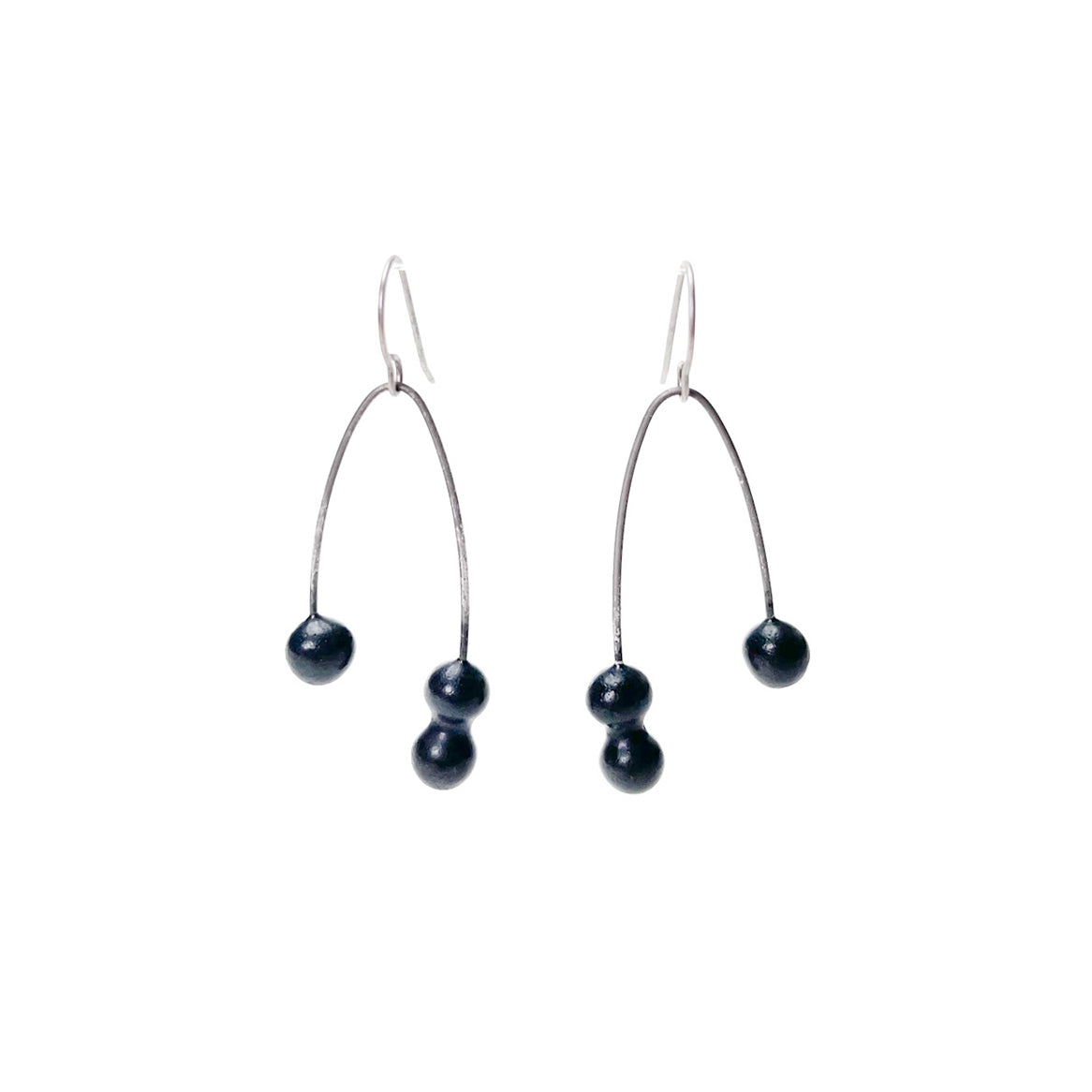 Black handmade earrings that resemble seeds. Hypoallergenic ear wires
