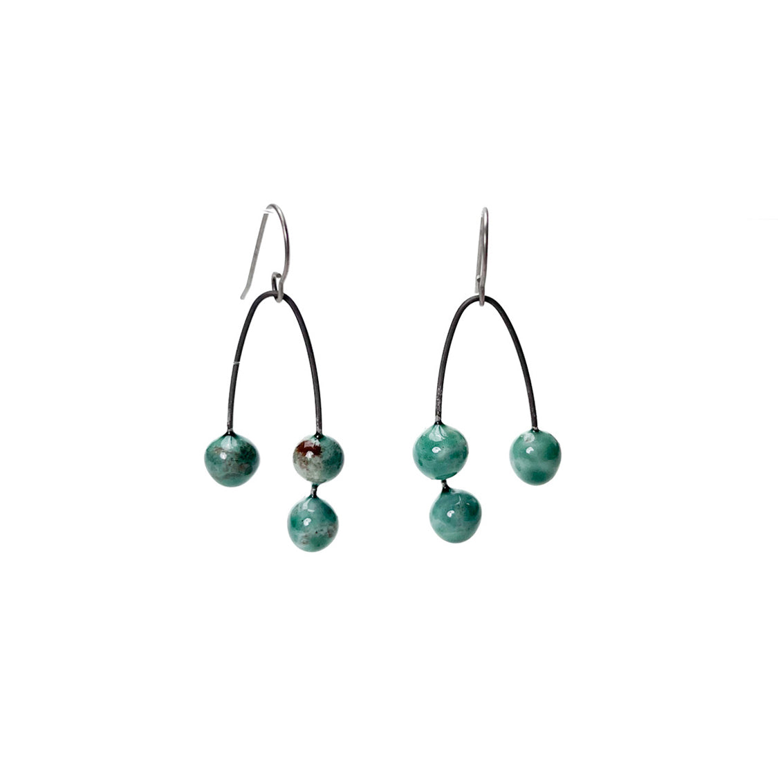 Green handmade earrings that resemble seeds. Hypoallergenic ear wires