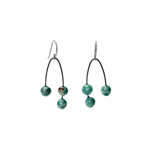 Green handmade earrings that resemble seeds. Hypoallergenic ear wires