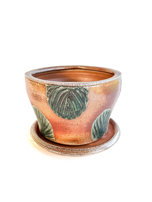 This wheel thrown handmade stoneware planter looks beautiful with a favorite plant inside! There is a saucer to catch the water that is included.