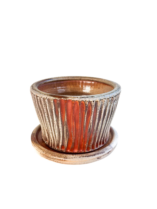 This wheel thrown handmade stoneware planter looks beautiful with a favorite plant inside! There is a saucer to catch the water that is included.