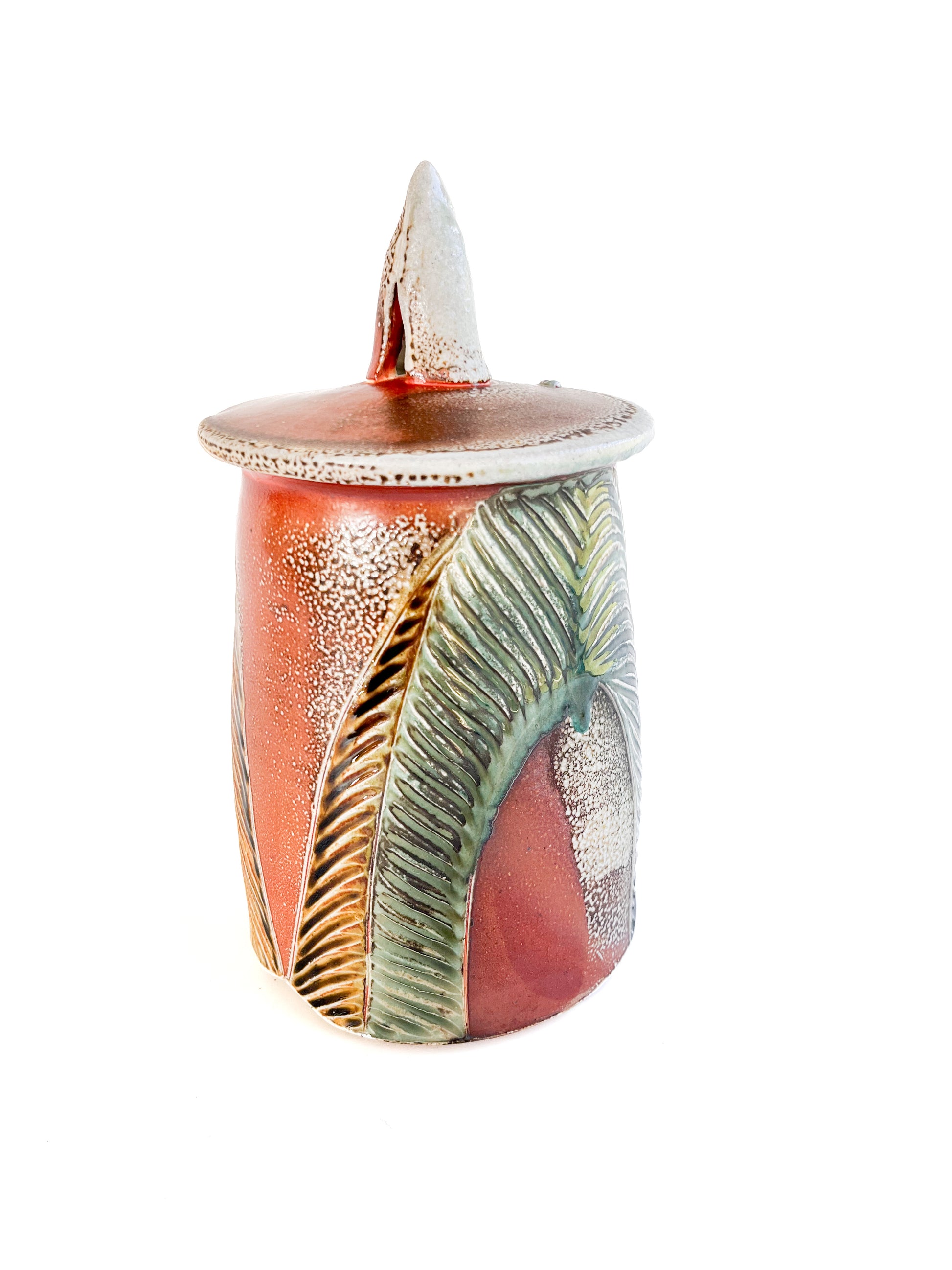 This medium sized handmade jar could be used to store coffee, tea bags, sugar, or candy. The leaf pattern that is hand carved is inspired by nature. 
