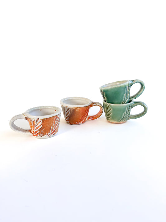 Brighten up your morning espresso with these unique cups! They have a handcarved leaf pattern around the sides.